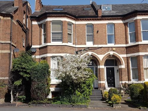 a brick house with a staircase in front of it at Warwick Place - Leamington Apartments in Leamington Spa