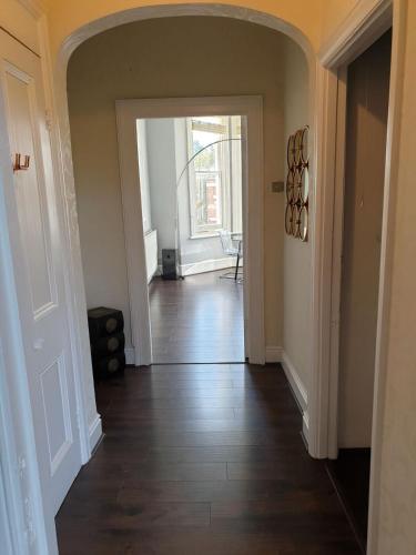 an empty hallway with a door leading to a room at Warwick Place - Leamington Apartments in Leamington Spa