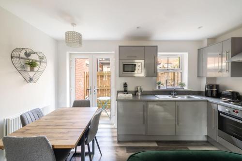 a kitchen and dining room with a wooden table at Host & Stay - Shipwright Lodge in Whitby