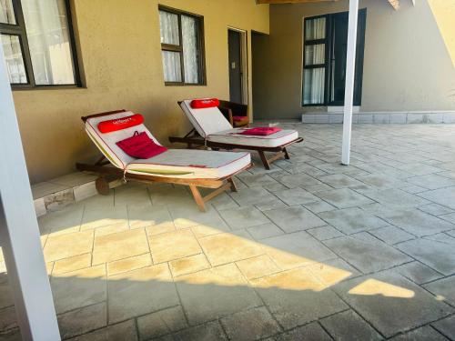 two lounge chairs sitting on a stone patio at Horizon Bed and Breakfast in Roodepoort