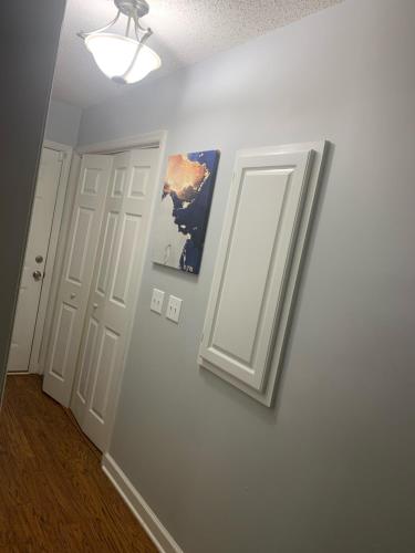 a hallway with two doors and a picture on the wall at House on the Hill in Columbia