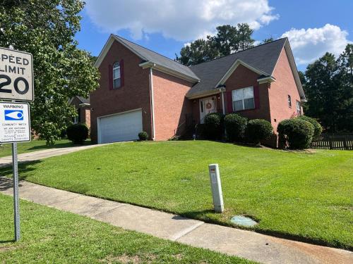 a speed limit sign in front of a house at House on the Hill in Columbia