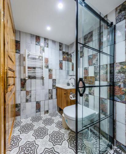 a bathroom with a toilet and a glass shower at Evra Suites Hotel in Istanbul