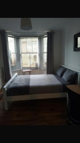 a bedroom with a large bed in front of a window at Number 14 in Ipswich