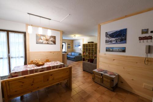 a room with a bed and a living room at Appartamento La Valeille in Cogne