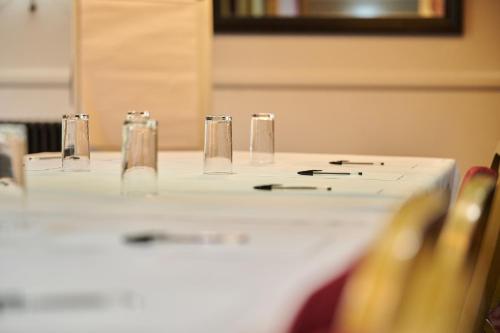 a table with glasses and pens on top of it at The Rutland Hotel in Sheffield