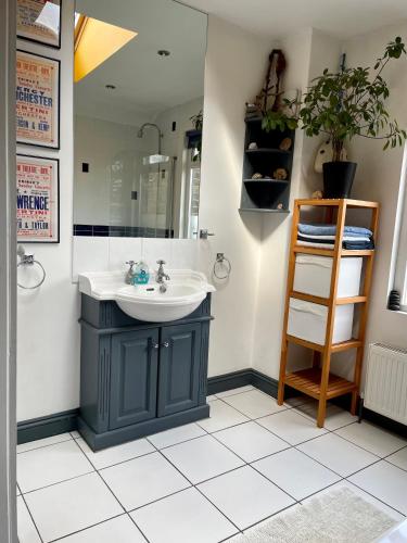 a bathroom with a sink and a mirror at Beautiful Victorian House in Central Chelmsford in Chelmsford
