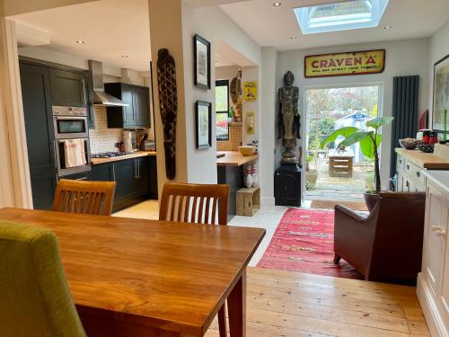 a kitchen and dining room with a table and chairs at Beautiful Victorian House in Central Chelmsford in Chelmsford