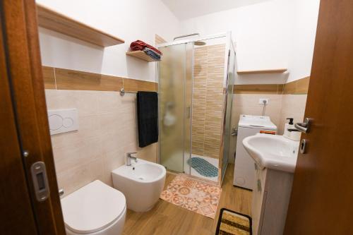 a bathroom with a toilet and a sink and a shower at Appartamento La Valeille in Cogne