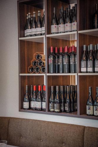 a shelf filled with lots of bottles of wine at Anett hotel in Vipiteno