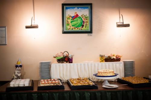 a table with several different types of food on it at Hotel Lilia in Golden Sands