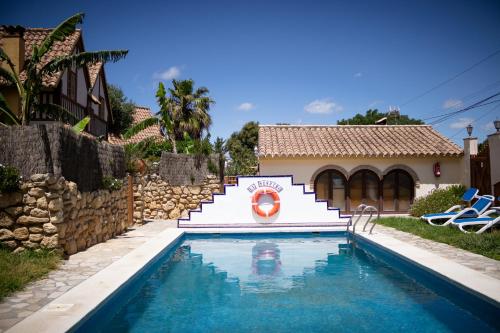 a swimming pool in front of a house at Casas El Suspiro in Zahora