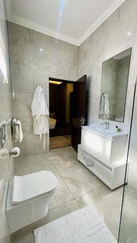 a white bathroom with a sink and a toilet at Zet On 9TH Avenue in Durban