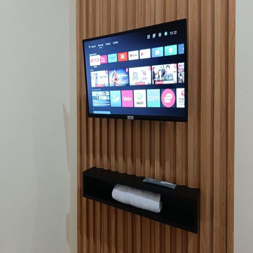 a flat screen tv sitting on top of a wooden wall at Nawasena Homey Syariah near Bandara Adisucipto 4 Mitra RedDoorz in Potrojayan