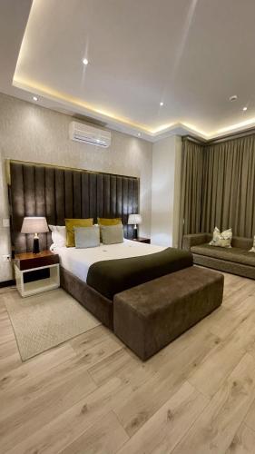 a large bedroom with a large bed and a couch at Zet On 9TH Avenue in Durban