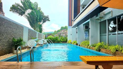 a swimming pool in front of a building at Апартаменты с видом на море на Карон Бич А 409 in Karon Beach