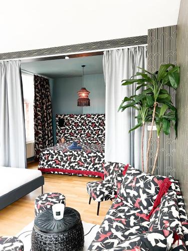 a living room with two beds and a couch at Le FauBourg Suites in Antwerp