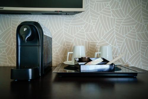 a desk with a lamp and books on a table at Bacolux Diana, Herculane in Băile Herculane