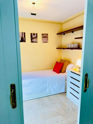 mała sypialnia z łóżkiem i biurkiem w obiekcie Habitación en el corazón de Alicante con vista Jardín w Alicante