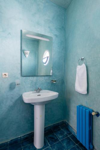 a bathroom with a sink and a mirror at Riad Asilah 32 in Asilah
