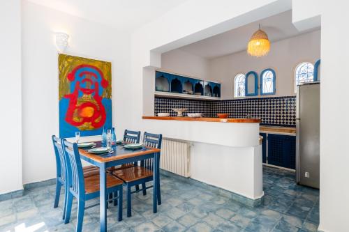 a dining room with a table and chairs at Riad Asilah 32 in Asilah