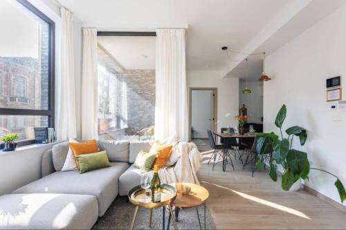 a living room with a couch and a table at Sunny haven in Antwerp