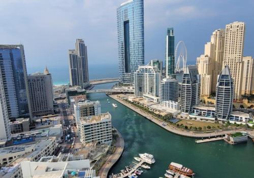 a view of a city with a river and buildings at Dubai Marina Walk Gem Modern Apartments with Pool & Gym access, Steps to Beach & Metro Managed by SunnyHomes in Dubai