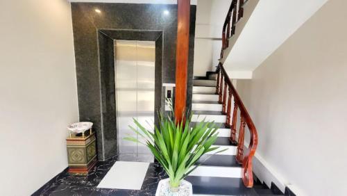 a hallway with a staircase with a plant at New Sun Hotel Sapa in Sa Pa