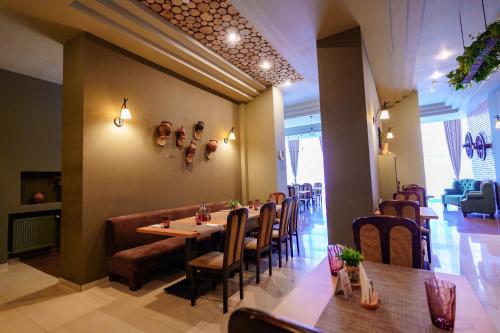 a dining room with a long table and chairs at Bacolux Diana, Herculane in Băile Herculane