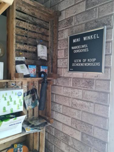 a brick wall with a sign on it at de Tweelingen in Schoonloo