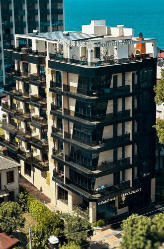 an apartment building with a balcony on top of it at Golden Sun Kobuleti in K'obulet'i