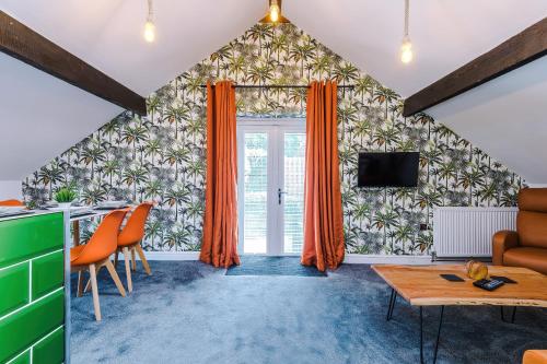 a living room with orange curtains and a table at 'Apple Store' - Mochdre Cottages in Mochdre