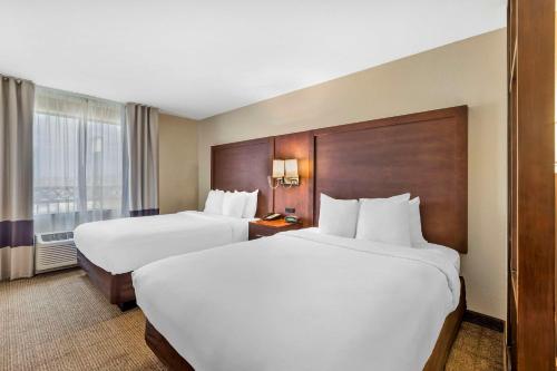 a hotel room with two beds and a window at Comfort Suites Blythe in Blythe