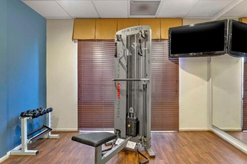 a room with a gym with a television and a chair at Comfort Suites Blythe in Blythe