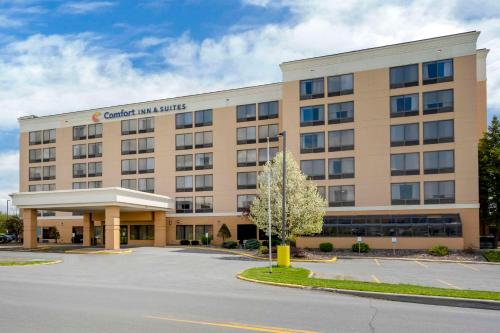 a large building with a parking lot in front of it at Comfort Inn & Suites Watertown - 1000 Islands in Watertown