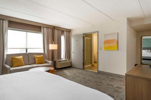 a hotel room with a bed and a television at Comfort Inn & Suites Watertown - 1000 Islands in Watertown