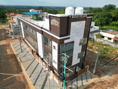 an overhead view of a building in a city at Magan Enclave in Kuttālam