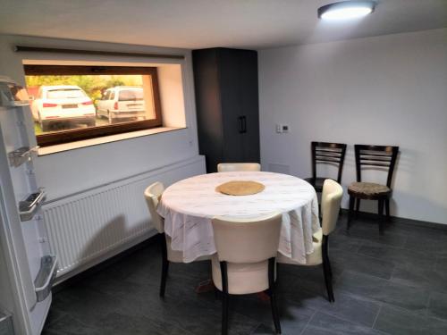 a dining room with a table and chairs and a window at Safrany kulcsoshaz in Odorheiu Secuiesc