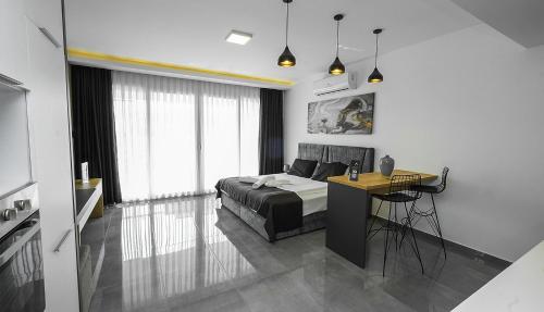 a bedroom with a bed and a desk in it at xo courtyard long beach in Iskele
