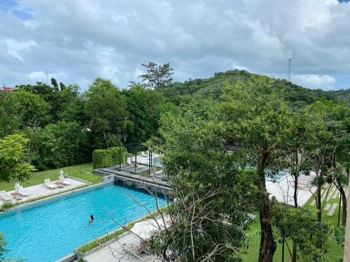 an overhead view of a swimming pool in a park with trees at The Gallery Hotel Nai Harn in Nai Harn Beach