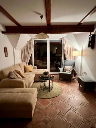 a living room with a couch and a table at Vineyard cottage Skriti raj in Leskovec pri Krškem