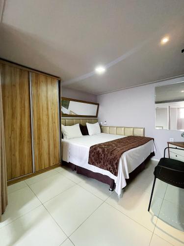 a bedroom with a large bed in a room at Studio Bangalô Belém Hospedagem in Belém