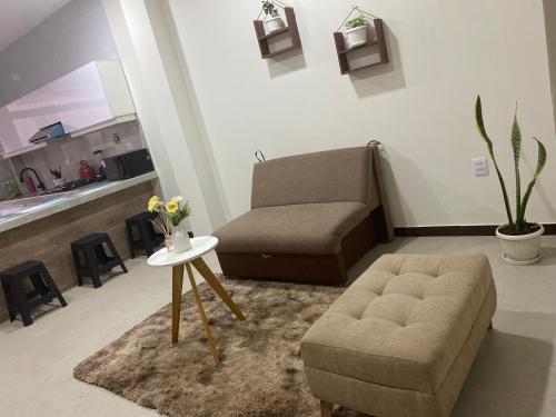 a living room with a couch and a chair at Garzonier vacacional in Sucre