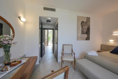 a living room with a bed and a table at Grand Hotel Masseria Santa Lucia in Ostuni
