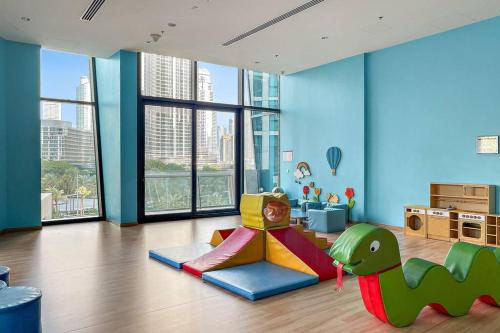 a childs room with a dinosaur themed play area at Skyline Views 2BR Near Burj Khalifa & Dubai Mall with Pool Access in Dubai