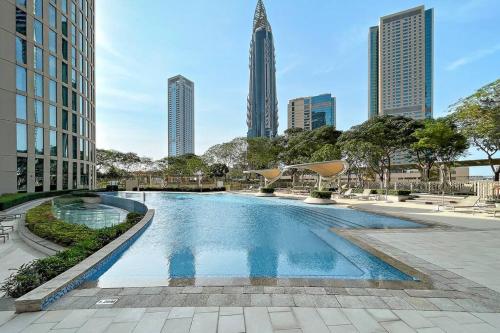 a swimming pool in a city with tall buildings at Skyline Views 2BR Near Burj Khalifa & Dubai Mall with Pool Access in Dubai
