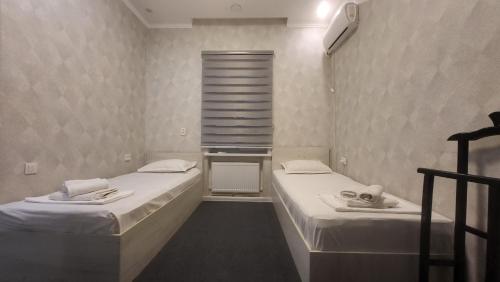 Postel nebo postele na pokoji v ubytování Shahriston Guest House