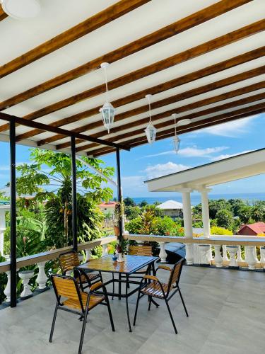 a table and chairs on a patio with a view at Oceanic View Apartments in Beau Vallon
