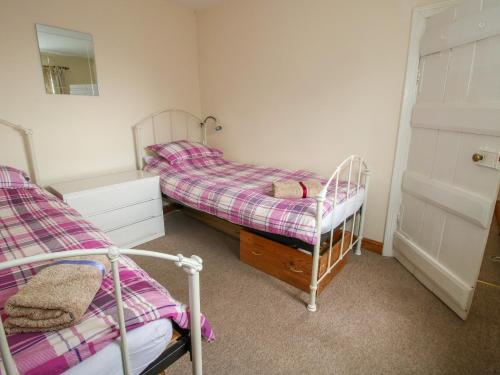 a bedroom with two bunk beds and a mirror at Old Bricklayer's Arms in Bishops Castle