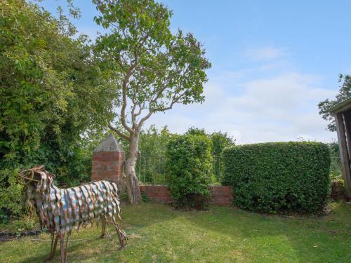 a statue of a cow standing in a yard at Old Bricklayer's Arms in Bishops Castle